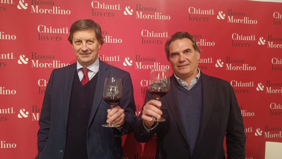 A photo of two gentlemen toasting with glasses of red wine at a "Chianti lovers & Rosso Morellino" event